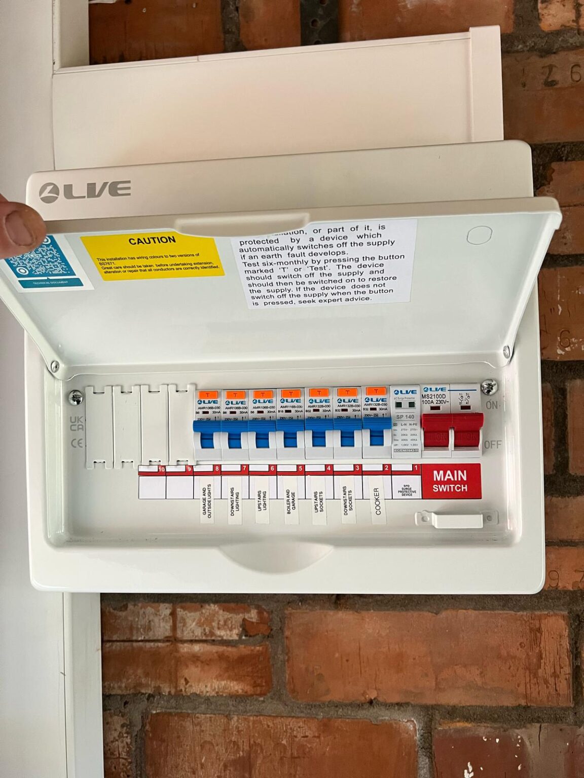 Newly installed consumer unit with labeled circuit breakers and main switch