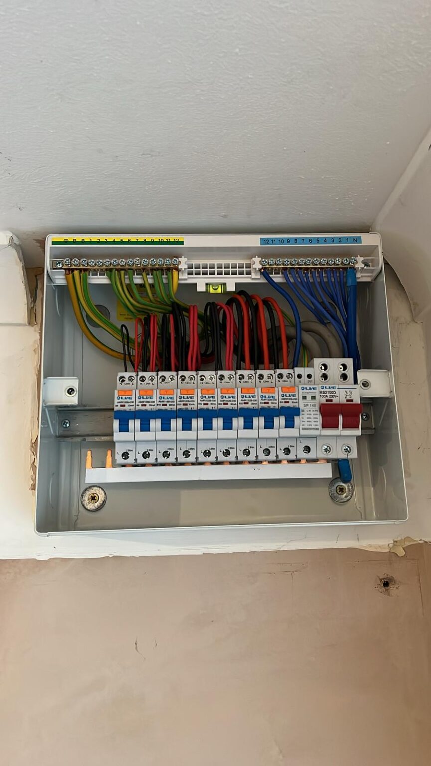 Neatly installed consumer unit with circuit breakers and labeled wiring