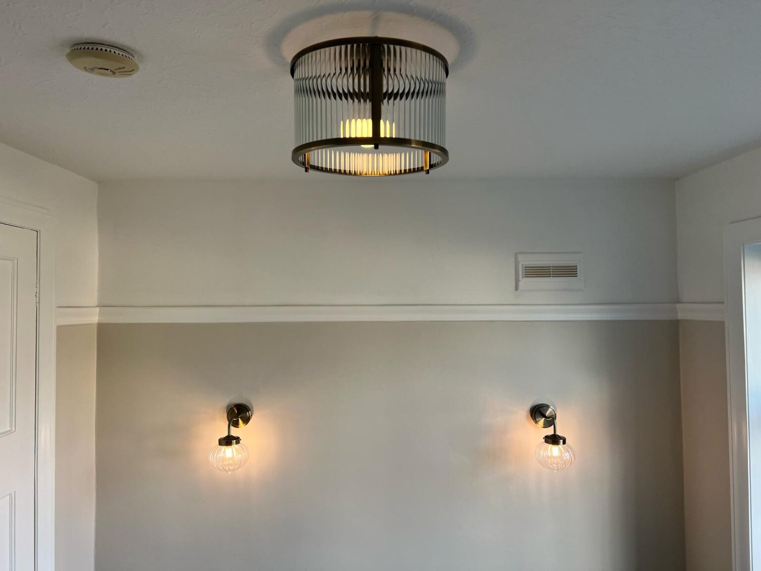 Modern hallway lighting with ceiling fixture and matching wall sconces