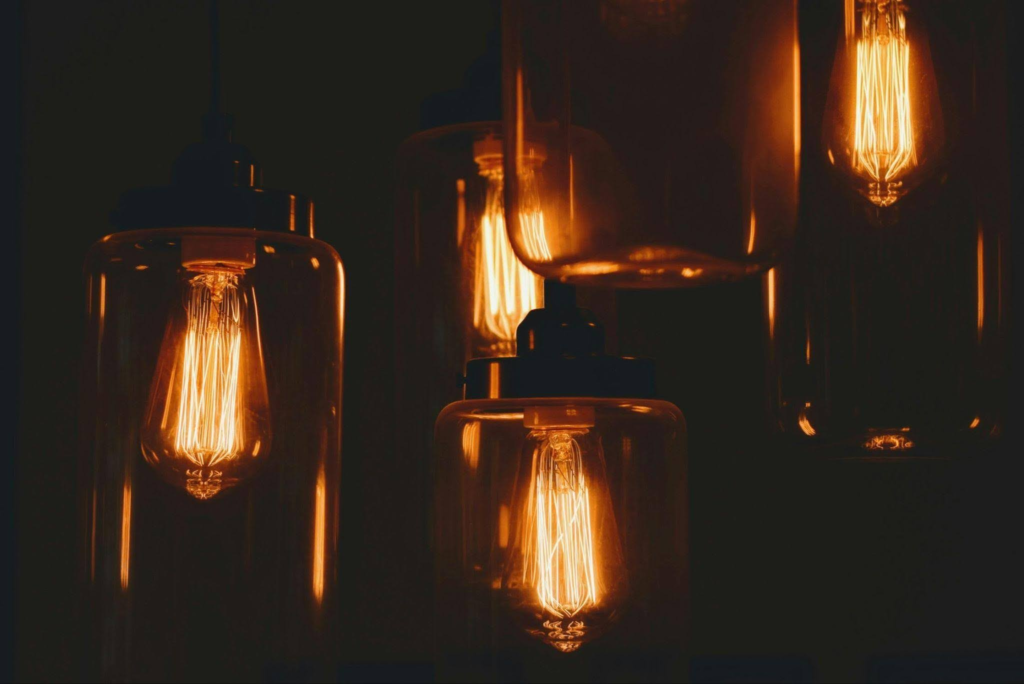 Vintage Edison light bulbs glowing warmly in a dark setting